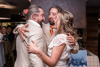 The couple hugging a loved one