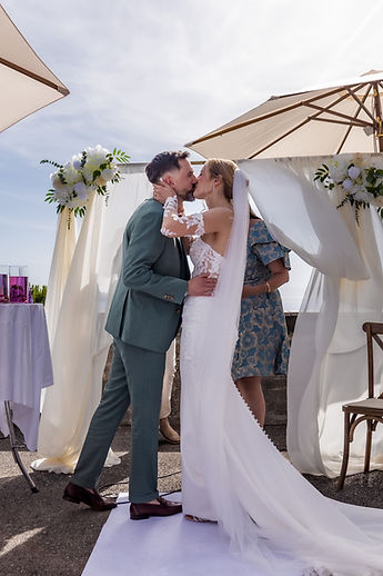 The couple's kiss beneath the white drapes