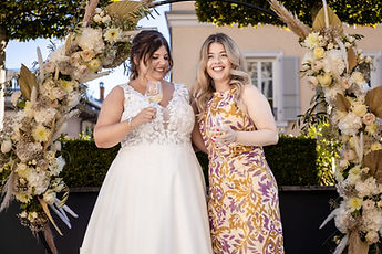 Sabrina laughing with a loved one under the arch