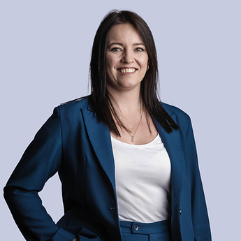 Portrait of a woman in a blue suit, hand in her pocket