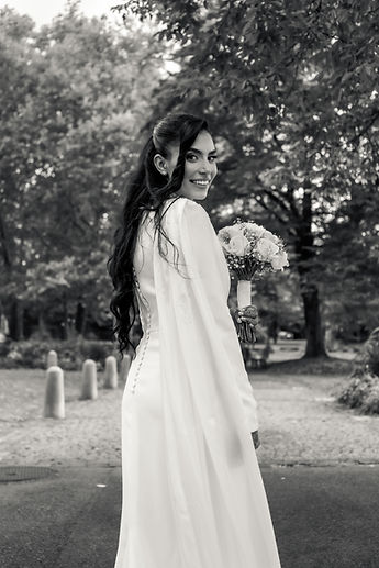 Leila from behind, looking over her shoulder, in black and white