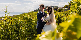 Lucie and Patrick behind the vine leaves