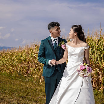 Newlyweds face to face, the bride holding her bouquet