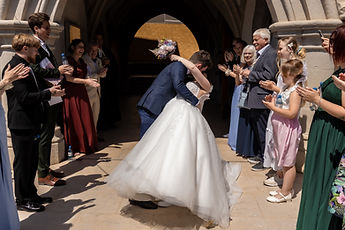 The couple hug as they leave the church