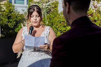Sabrina reading her vows into the microphone