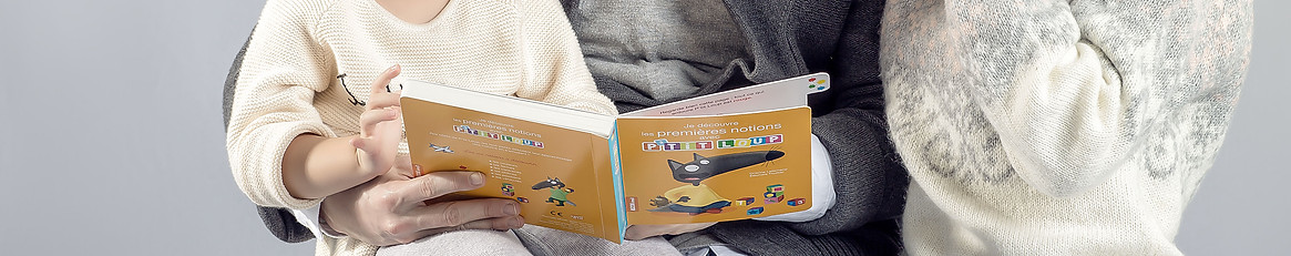 Un livre d'images ouvert sur les genoux d'une famille