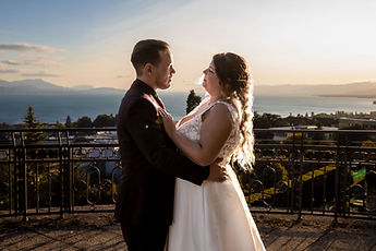 The couple embracing, facing the mountains