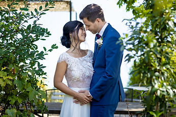 Liliane and Antoine surrounded by greenery, all smiles