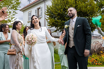 The couple laugh among their guests
