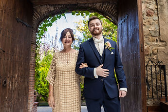 Jean walks towards the ceremony, arm in arm with a loved one