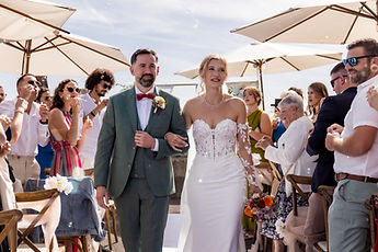 Arm in arm, the couple leave the ceremony