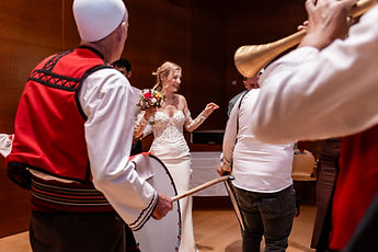 Musicians in traditional costume around the bride
