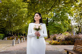 Leila facing the camera, her bouquet in front of her