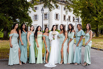 The bride surrounded by her friends in soft green dresses