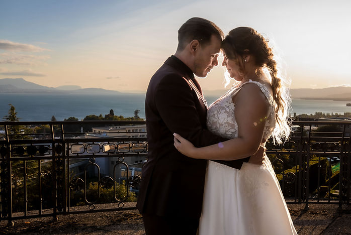 Sabrina and Idrisse forehead to forehead at sunset, facing Lake Geneva