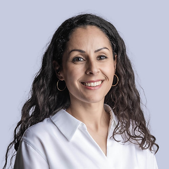 Portrait of a woman with curly hair in a white blouse