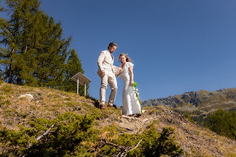 Charlotte and Derek on a hilltop, under a wide blue sky