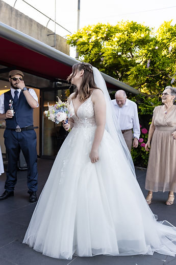 Lucie, from behind, about to throw her bouquet
