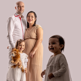 Family portrait in the studio: the parents and their two children
