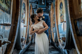 A tender moment in the cellar, between the painted casks