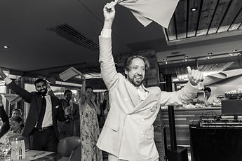 Derek whirling his napkin, in black and white