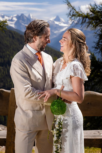 Charlotte and Derek embracing in front of the peaks