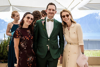 One of the grooms poses with three guests