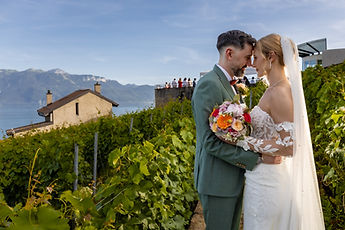 The couple embracing in the vineyards, the bouquet between them