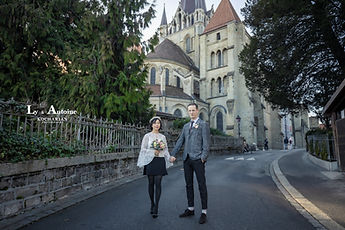 Ly and Antoine hand in hand in front of Lausanne Cathedral