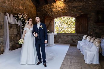 The newlyweds walk back up the white aisle, arm in arm