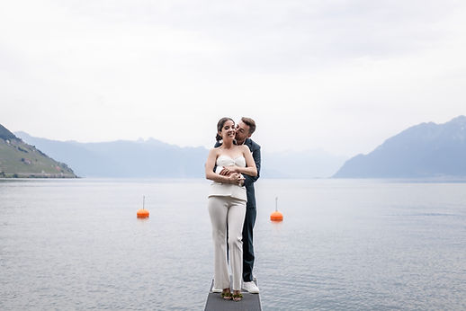 The couple embracing by Lake Geneva