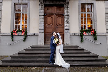 The couple kissing on the steps