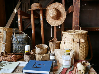 A display of basketry, books and naturally dyed fabrics.