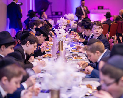group of young boys eating at a party having their photo taken, party photography