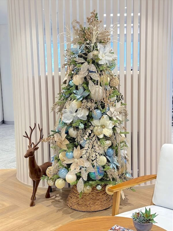 Elegant pastel Christmas tree styled with soft blue, champagne and ivory ornaments, designed for a modern office environment by Sydney Christmas decorator Jake Decorates.