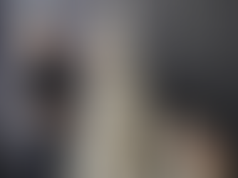 Designer styling a soft white Christmas tree with crystal inspired decorations and warm lights, reflecting modern Christmas colour trends for 2026.