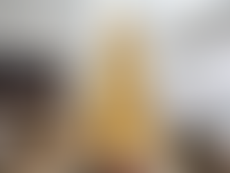 A 14-foot luxury Christmas tree styled by Jake Decorates in Sydney, featuring glowing LED sparkle balls, oversized gold ornaments, and champagne palm fronds. The frosted tree is positioned beside tall windows with sheer curtains, creating a radiant, elegant holiday display in a modern living room with a fireplace, gold reindeer, and toy train set.