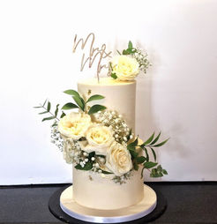 2 tier wedding cake decorated with fresh white roses and Mr & Mrs topper