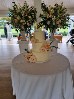 3 tier wedding cake set up on a white table