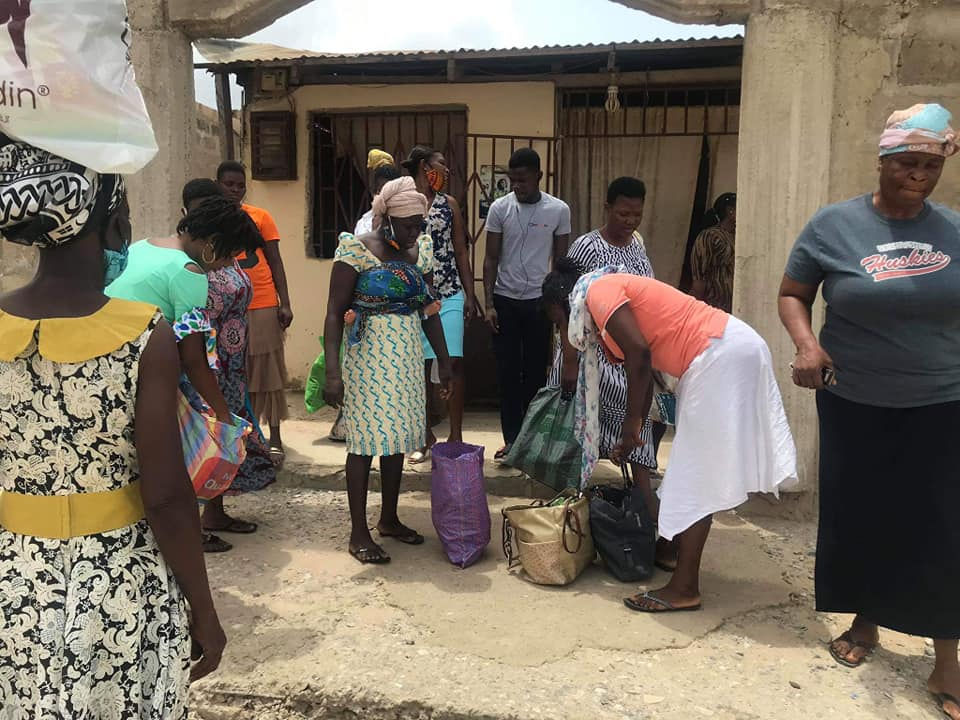 WOMEN COLLECTING FOOD AT THE CHURCH