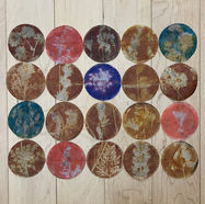 Colourful round tea bags with images of wildflower sewn in a grid to create a placemat.