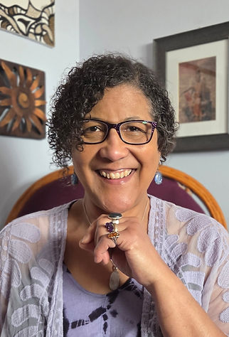 Catherine FireSeed Astrologer smiling warmly in consulting Office