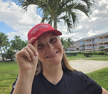 White lady using Make America Kind Again cap