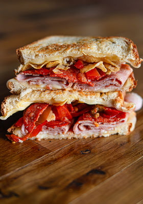 Tomesto: Sunflower basil pesto, mozz, cheddar, tomatoes, garlic seasoning, on sourdough