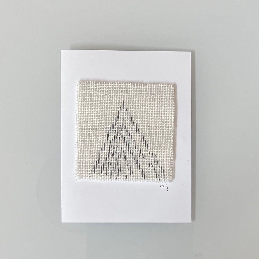 Embroidered gray mountain design on linen card
