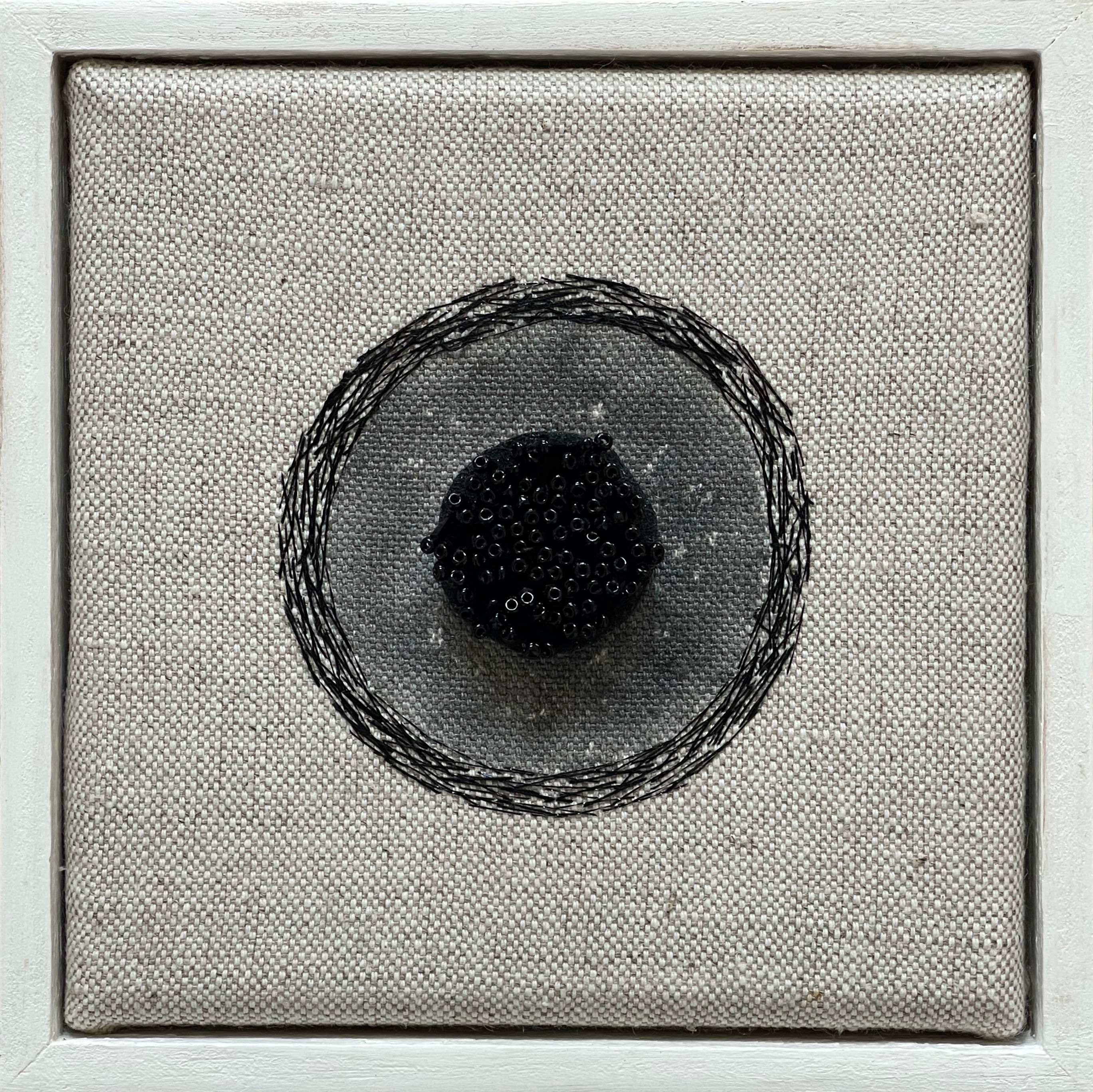 Circular monochrome artwork, textured canvas background