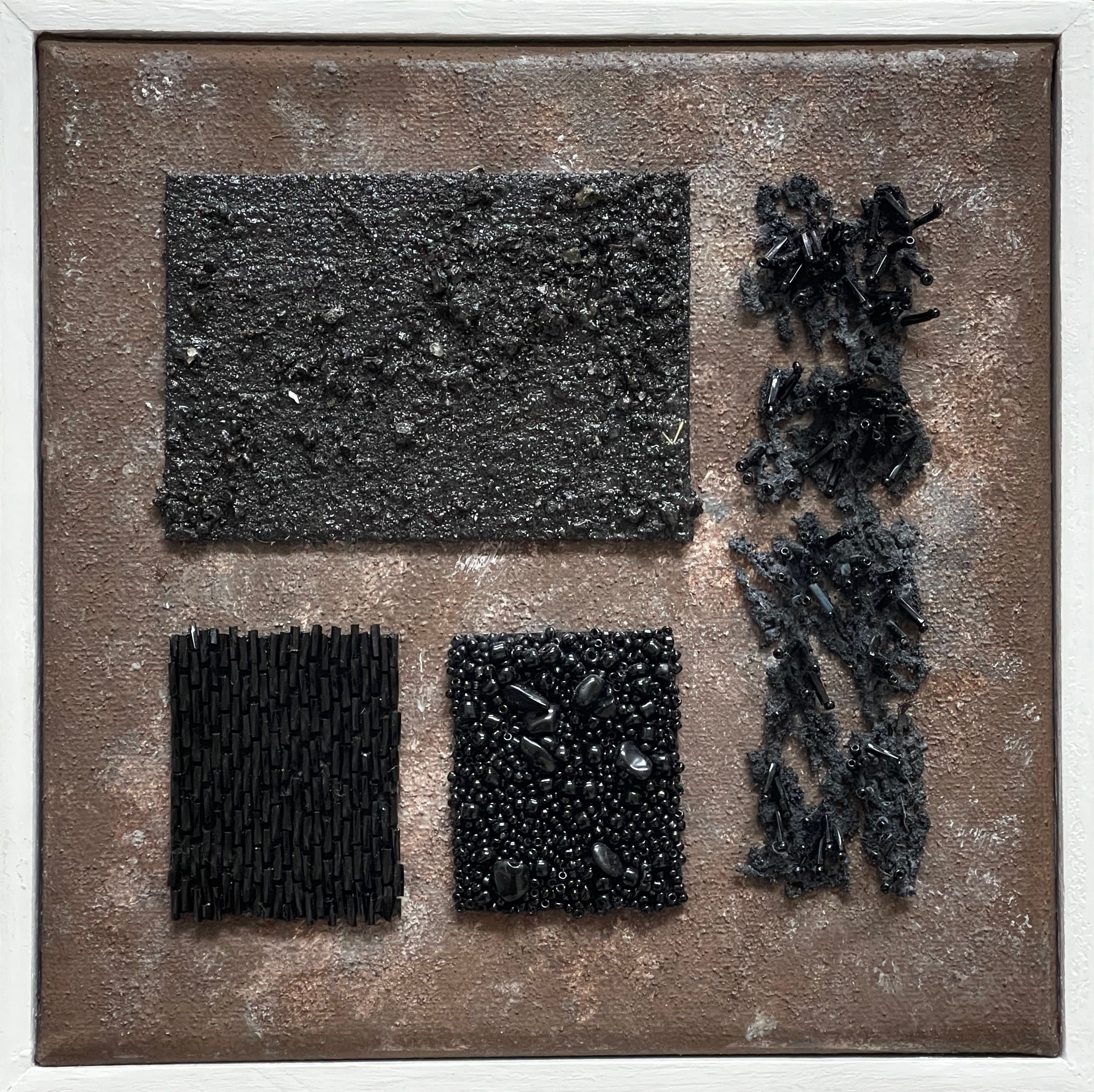 Abstract black mix media art with sand and beads on brown background, framed