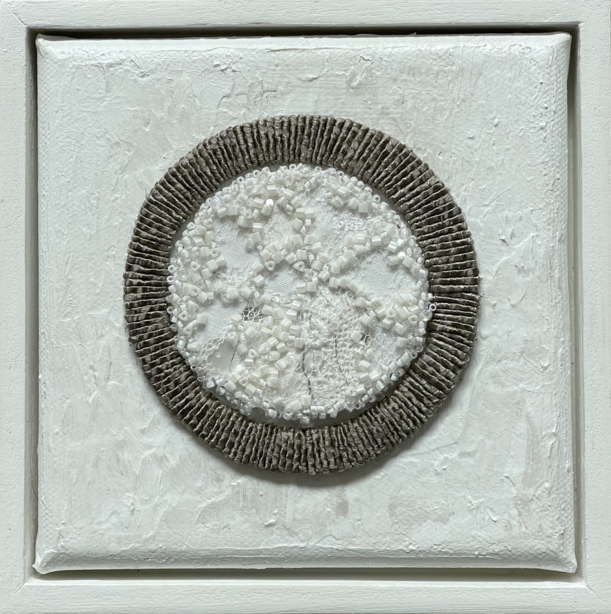 White textured artwork, circular design, framed