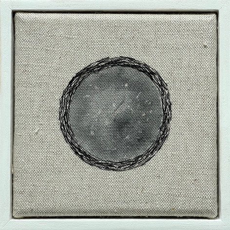 Abstract art, with stitched center on a grey fabric