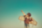 Kid pilot with toy jetpack against autumn sky background. Happy child playing outdoors.jpg